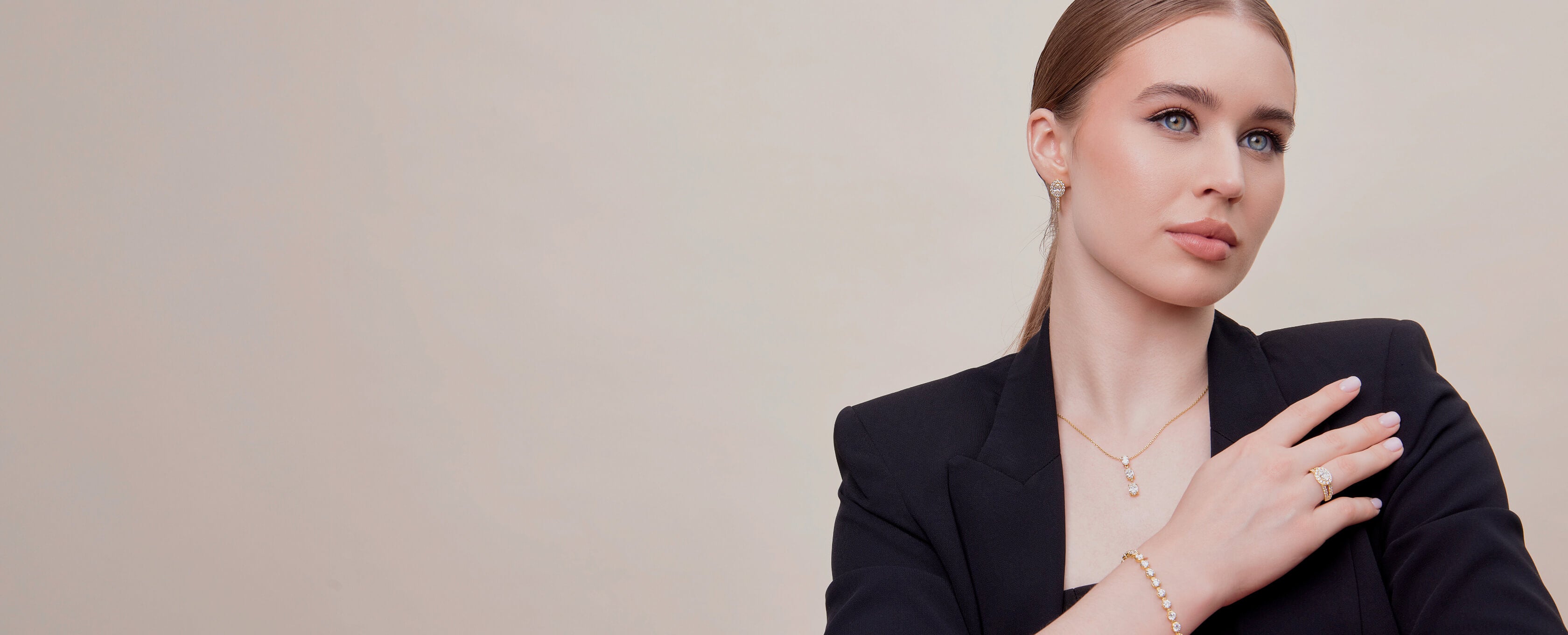 Woman wearing a necklace with a plain background